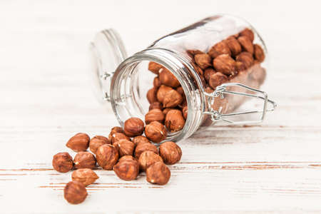 Closeup of hazelnuts in a glass containerの写真素材