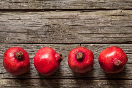 Juicy pomegranates on wooden tableの写真素材
