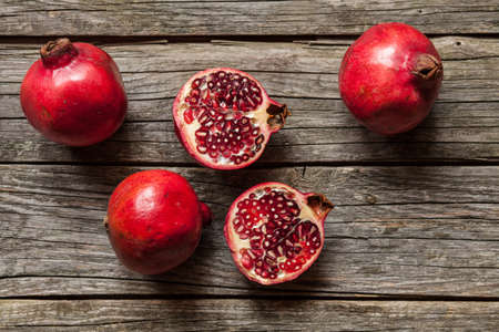 Juicy pomegranates on wooden tableの写真素材