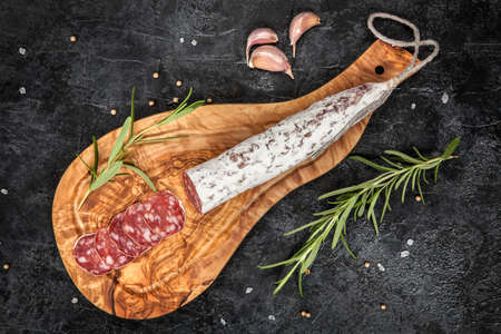 Traditional italian salami on dark background