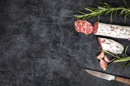 Traditional italian salami on dark background