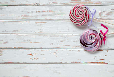 Lollipop candies on white wood backgroundの写真素材