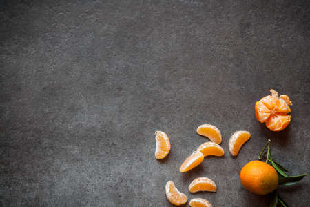 Tangerines with leaves on gray stone backgroundの写真素材