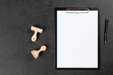 Black clipboard on leather surface tableの写真素材