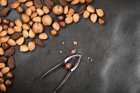 Assortment of nuts on dark slate background
