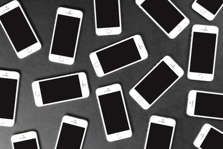 WROCLAW, POLAND - DECEMBER 16, 2016: Apple iPhone 5s smartphones lying on dark surfaceのeditorial素材