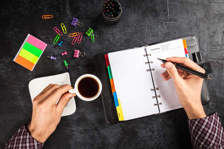 Man writing in organizer