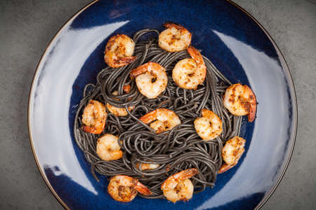 Black pasta with shrimpsの写真素材