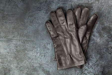 Two pairs of leather gloves on dark backgroundの写真素材