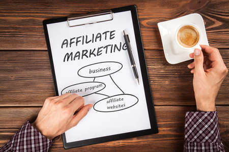 Clipboard on a wooden tableの写真素材