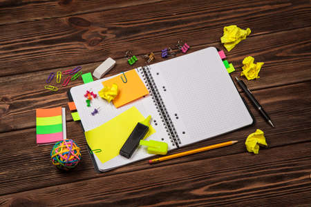 Open notepad with office suppliesの写真素材