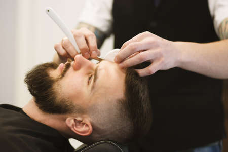 Professional barber doing a haircutの写真素材