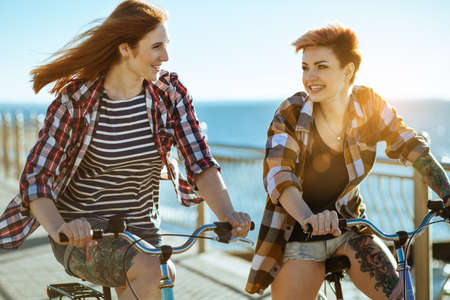 Two women with bicycelsの写真素材