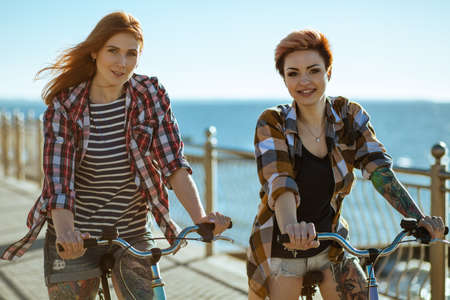 Two women with bicycelsの写真素材