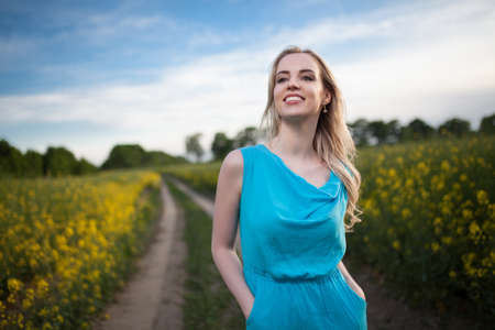 Young beautiful woman in the fields
