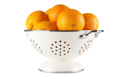 Fresh oranges in a colanderの写真素材