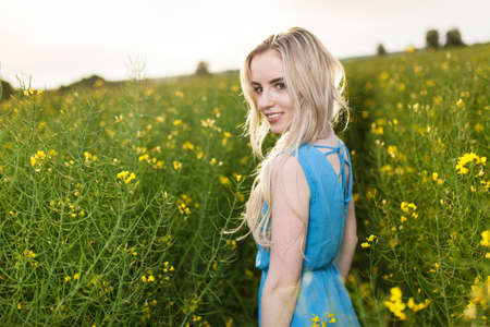 Young beautiful woman in the fields