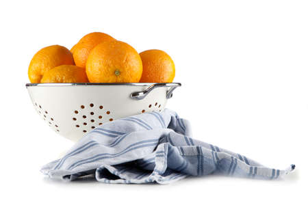 Fresh oranges in a colanderの写真素材