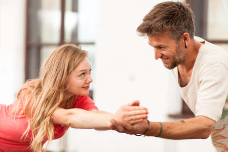 Yoga instructor teaching a woman