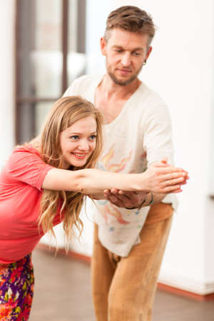 Yoga instructor teaching a womanの写真素材