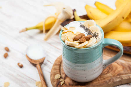 Banana yoghurt with seeds and cornflakesの写真素材