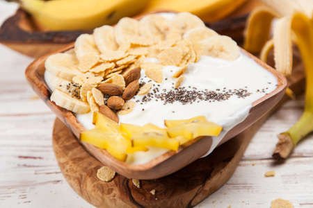 Banana yoghurt with seeds and cornflakesの写真素材