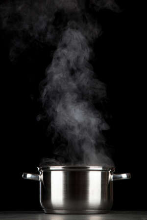 Steaming pot on black backgroundの写真素材