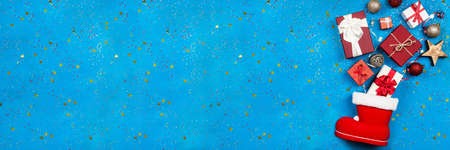 Lots of Christmas presents flowing out of Santa's stockingの写真素材