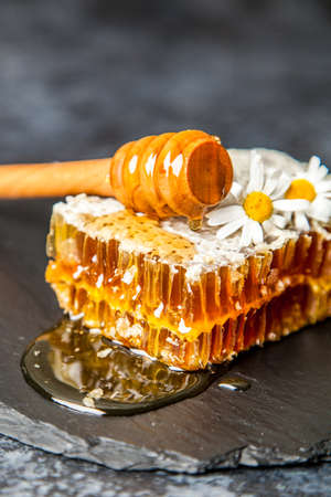 Honeycomb on a wooden boardの写真素材