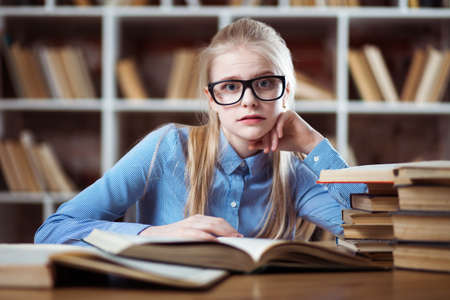 Teenage girl in a libraryの写真素材