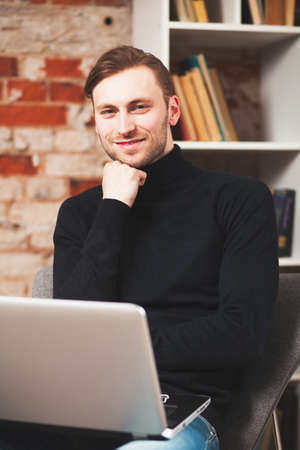 Young man with a laptopの写真素材