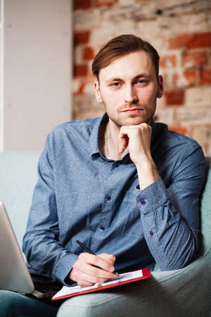 Young man with a laptopの写真素材