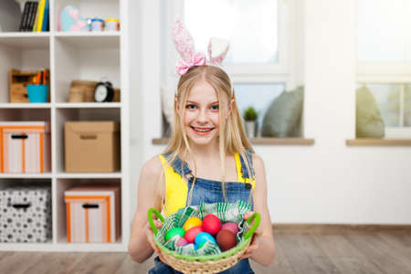 Teenage girl holding Easter eggs