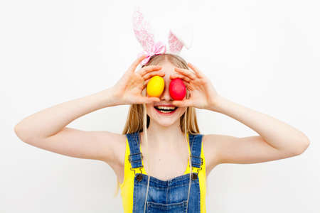 Teenage girl holding Easter eggsの写真素材