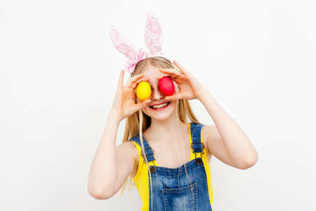 Teenage girl holding Easter eggsの写真素材