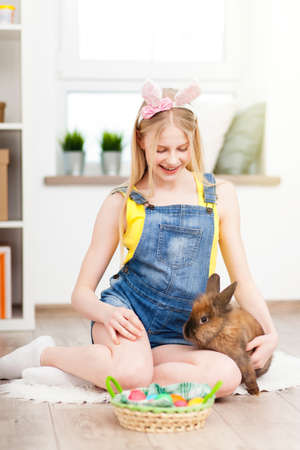 Teenage girl holding Easter eggs