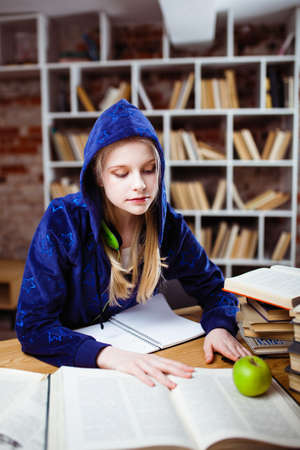 Teenage girl in a libraryの写真素材