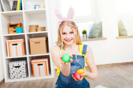 Teenage girl holding Easter eggs