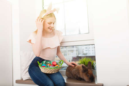 Teenage girl holding Easter eggsの写真素材