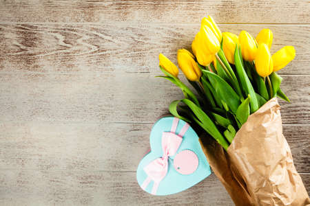 Yellow tulips on wooden backgroundの写真素材