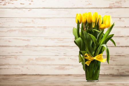 Yellow tulips on wooden backgroundの写真素材