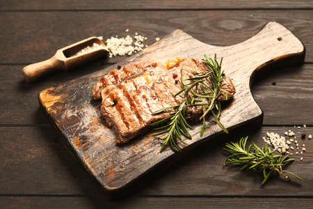 Grilled steak on wooden cutting boardの写真素材