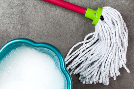 Cleaning supplies on grey background