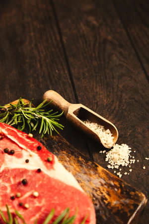 Raw steak on a wooden cutting boardの写真素材