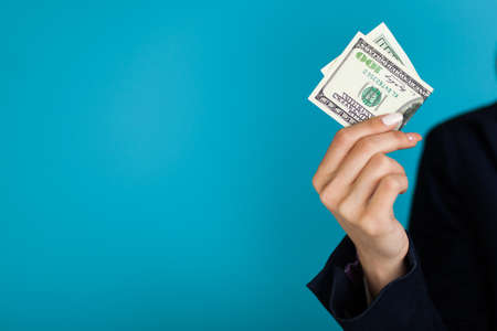 Woman holding a 100 dollar bill