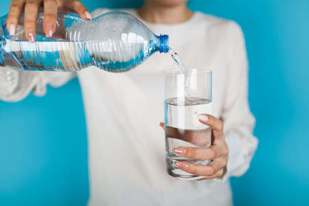 Woman filling a glass of water