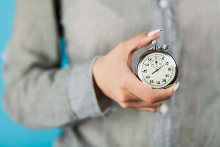 Female hand holding a stopwatch