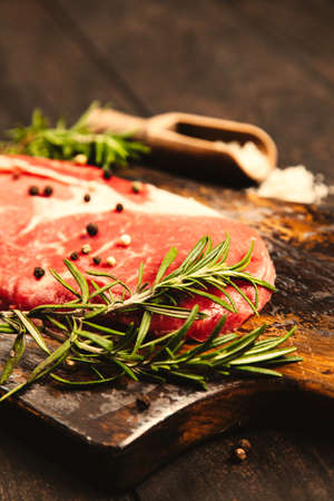 Raw steak on a wooden cutting boardの写真素材