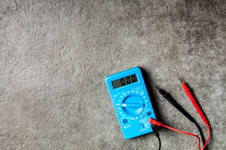 Digital multimeter on grey backgroundの写真素材