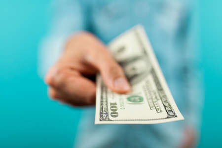 Man holding a hundred dollar bill